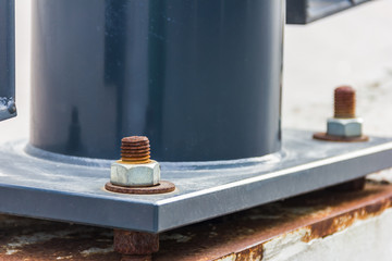 Dark metal column with bolts