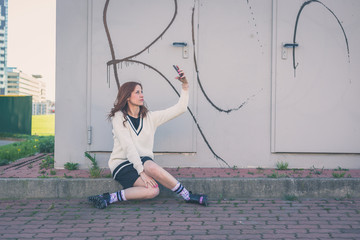 Beautiful girl taking a selfie in an urban context