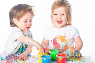 Fototapeta premium Little boy and girl playing with paints