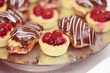 Mini tarts with berries, and choloclate cakes