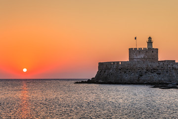 sunrise in Mandraki harbour. Rhodes, Greece
