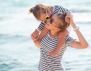 Mother with daughter on the beach