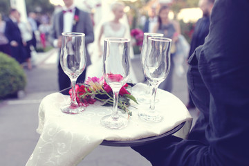 Waiter with four glasses of champagne