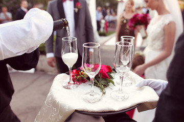 Waiter with four glasses of champagne