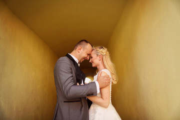 Bride and groom in a yellow tunnel
