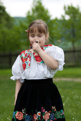 Little girl in traditional costume with flowers