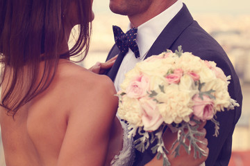 Detail of a bride and groom embracing