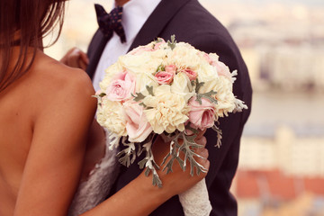 Detail of a bride and groom embracing