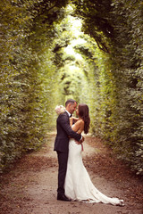 Vertical photograph of a bride and groom embracing
