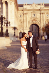 Vertical photograph of a bride and groom looking at each other