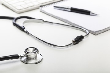 Laptop. Stethoscope on doctor&#39;s desk with keyboard and pad