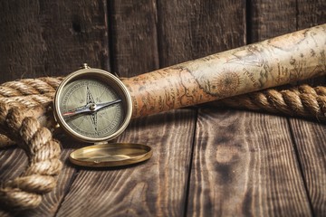Abstract. Old compass and rope on vintage map