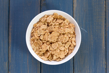 cereals in bowl on blue background