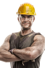 portrait of dirty worker with helmet crossed arms