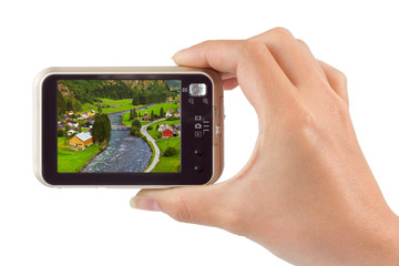 Hand with camera and Norway travel photo