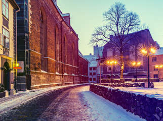 Obraz premium Medieval street in old Riga city at night, Latvia, Europe