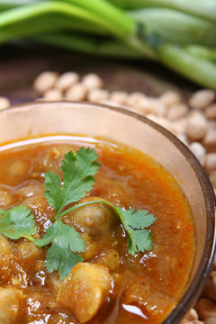 indian spicy chana masala with raw chickpeas
