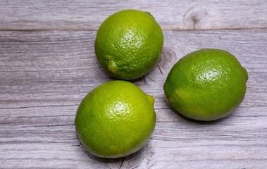 Fresh limes on wooden background