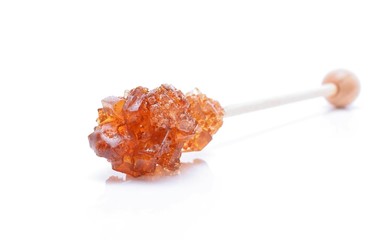 Brown sugar crystal on wooden stick