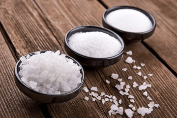 sea salt different grinding in bowls on wooden background