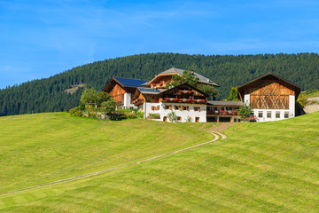 Fototapeta na wymiar Farm houses on hill in Val Di Funes mountain valley, Dolomites