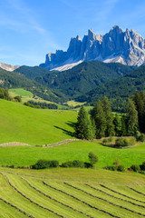 Farming field in Dolomites Mountains in Val di Funes valley