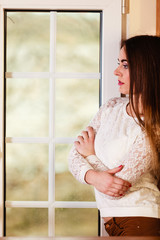 Beautiful woman looking through window.