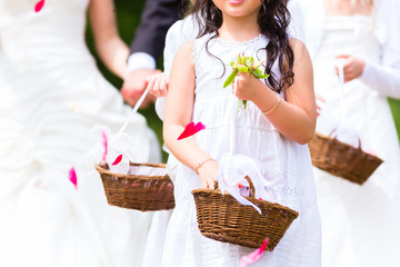 Wedding bridesmaids with flower petal basket