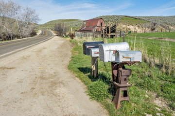 Country road with mail boxes and barn