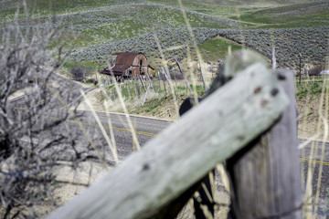 Unique view of a farm barn with fence post