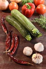 Fresh vegetables and ingredients for pizza on wooden background