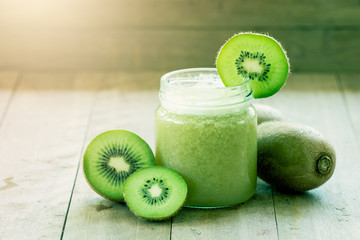 Sweet green color kiwi juice blened on wooden background