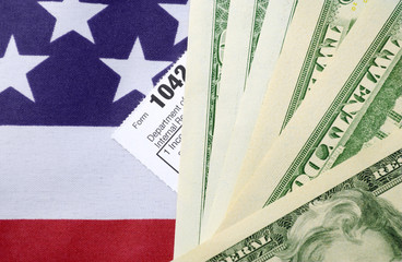USA Tax Day concept with income tax form and cash on stars and s