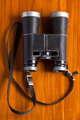 Vintage binoculars on wood