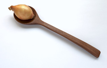 Onion on wooden spoon