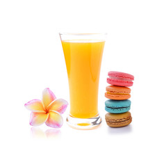 Orange juice and colorful macaroons  on white