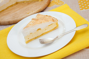 The piece of homemade cheesecake is on white plate