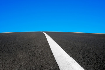 Asphalt road with white line and blue sky