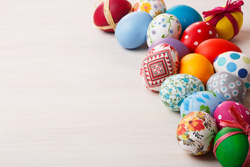 Fototapeta na wymiar Colorful painted easter eggs on a bleached wooden table