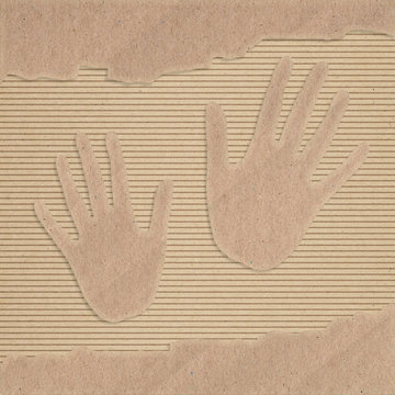 Two hand cut out on a corrugated cardboard