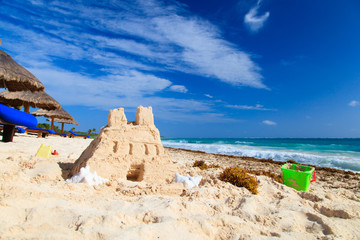 Sand castle with shells built on the beach