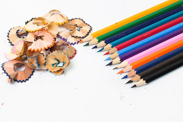 Colour pencils with sharpening shavings isolated on white