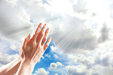 Human hands on sky background