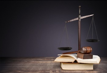 Law. Golden scales of justice, gavel and books isolated on white