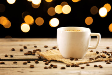 Cup of coffee on table on brown background