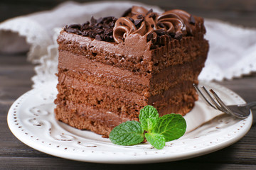 Tasty piece of chocolate cake with mint