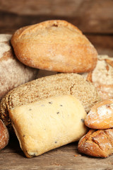 Different fresh bread on old wooden table