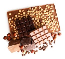 Chocolate bars with hazelnuts and coffee beans isolated on