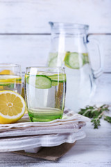 Fresh water with lemon and cucumber in glassware