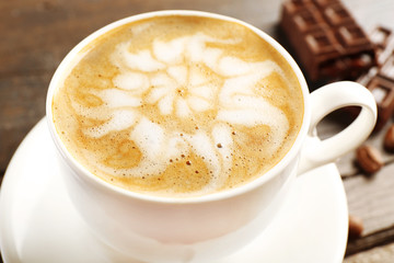 Cup of coffee latte art with grains and chocolate